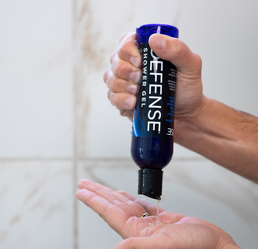 Defense Body Wash shower gel being dispensed into hand